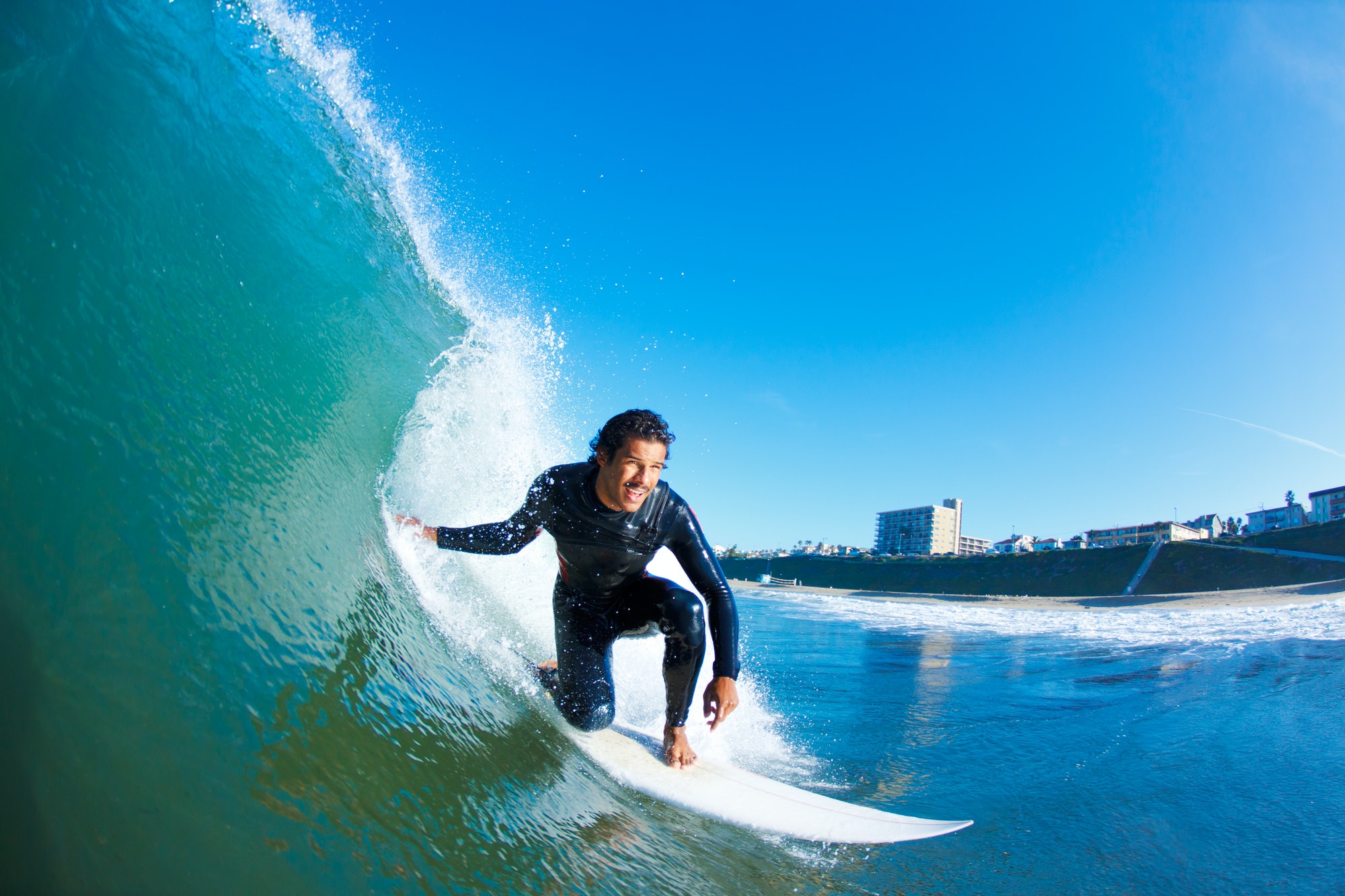 A surfer riding a long wave, representing the style of point break found at The Bay in Imsouane