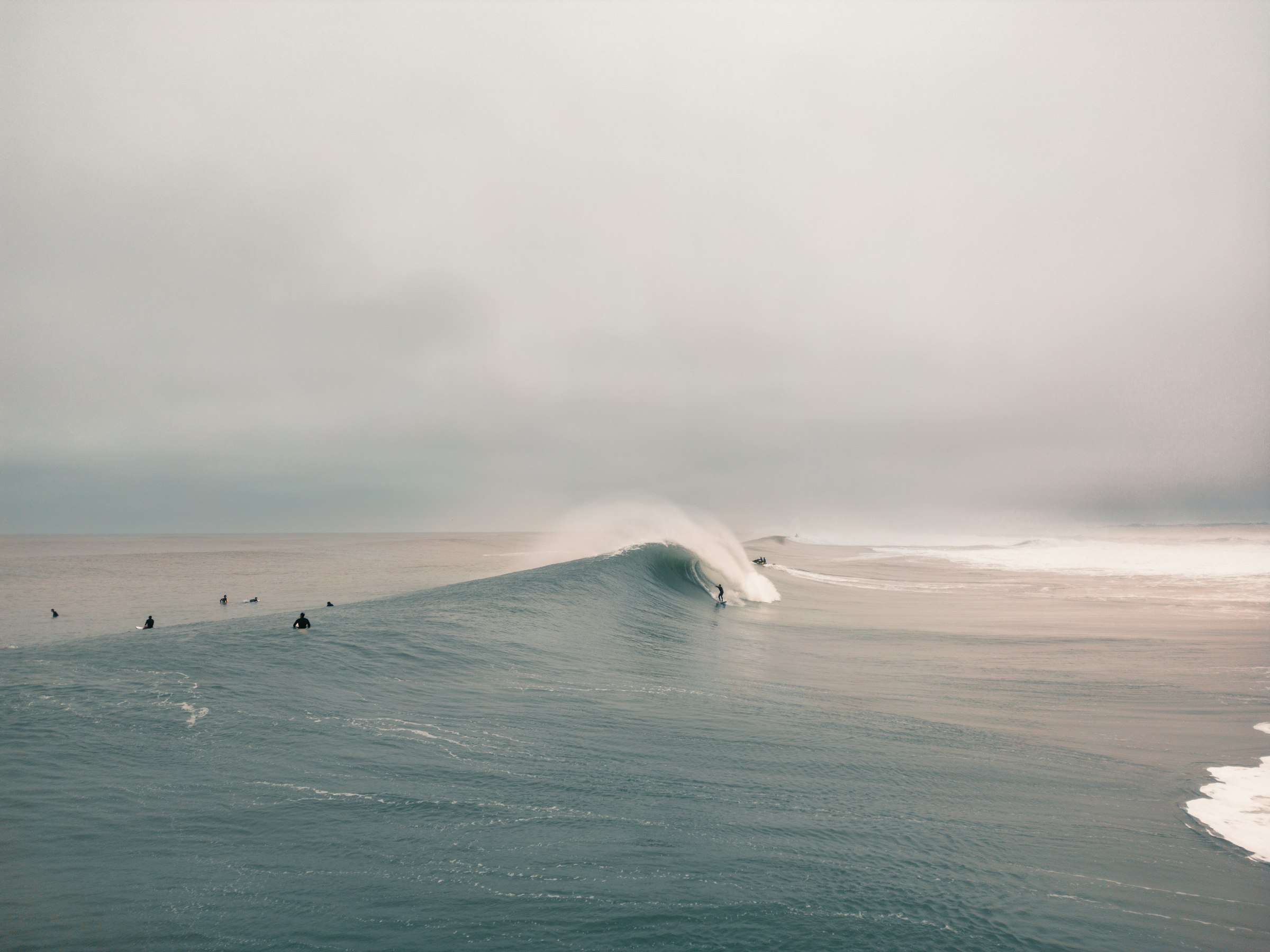 Group surf lesson on a wave, illustrating the best time to surf Morocco